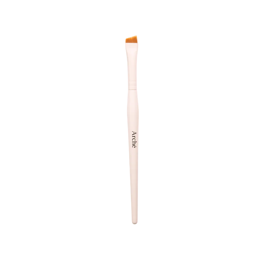 Makeup brush with a wooden handle and orange bristle tip on a white background